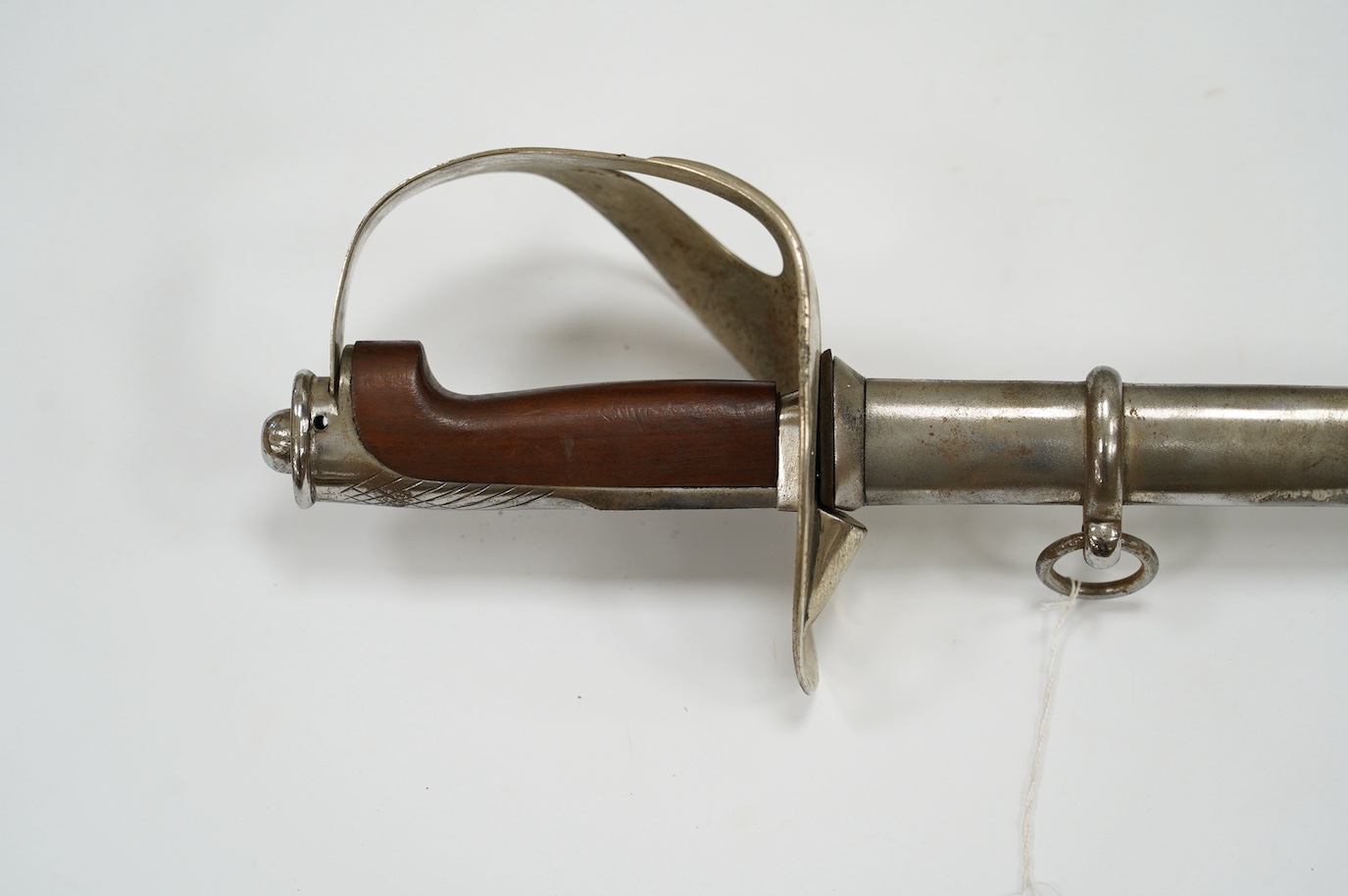 An Italian WWI cavalry trooper’s sword, pipe back blade, pierced guard, wooden grip, in its steel scabbard, blade 91cm. Condition - fair